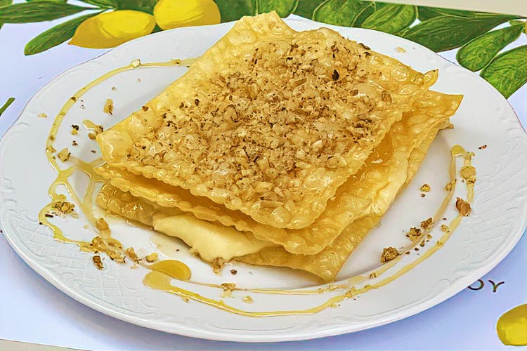 Traditional Greek diples drizzled with honey and walnuts at Yioryitsas Backyard in Kardamyli, Greece